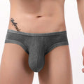 Men's CJ brand low waist sexy back hollow briefs with three-dimensional design, showcasing sleek black fabric and modern fit.
