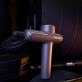 cj gym massage gun with ergonomic handle and multiple attachments for muscle recovery and relaxation.