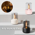 Candlelight Aroma Diffuser by CJ with USB port, cool mist, and night light, showing the diffuser emitting a gentle mist in a cozy setting.