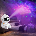 Mini astronaut star projector lamp by CJ displaying flowing colorful starry sky projection for creative galaxy atmosphere night light.