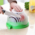 Manual food chopper by cj with a container, used for slicing and dicing vegetables like onions, tomatoes, and potatoes.