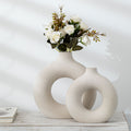 Frosted biscuit-shaped flower arranging device by CJ featuring textured particles, designed for floral display and decoration.
