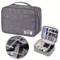 Waterproof electronics organizer bag by CJ with multiple compartments for travel cables, chargers, and digital accessories.