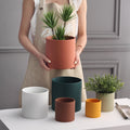 Colorful Nordic industrial ceramic flowerpot with green succulents, cylindrical shape, drainage hole, and matching tray by CJ.